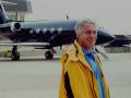 Jeffrey Epstein standing in front of one of his private aircraft.