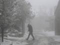 Un hombre camina este martes por una calle de O Cebreiro, Lugo, cubierta de nieve