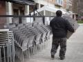 Un camarero coloca sillas de una terraza de una céntrica calle de Pamplona.