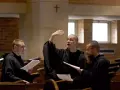 Tres jóvenes benedictinos ensayan para una misa en latín en su convento de Atchison