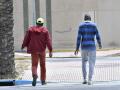 Dos inmigrantes subsaharianos pasean frente a establecimiento hotelero ?Ejido Hotel? en el municipio almeriense de El Ejido. El Ejido y Adra son dos municipios del Poniente almeriense que en las últimas semanas han mostrado su rechazo frontal a la apertura de centros de acogida temporal de inmigrantes procedentes de Canarias, aduciendo la presión migratoria y la alta frecuentación de pateras y narcolanchas en sus costas. EFE/ Carlos Barba