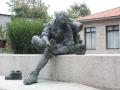 Estatua de un peregrino mirándose el pie