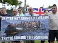 Protesters hold a banner depicting migrants crossing the Channel on a dinghy reading "They're not going to Rwanda, they're coming to Rushmoor" during a 'Enough is Enough' demonstration called by far-right activists near a hotel housing asylum seekers in Aldershot on August 4, 2024. Far-right protesters clashed with British police during tense rallies as unrest linked to disinformation about a mass stabbing that killed three young girls spread across the UK. (Photo by JUSTIN TALLIS / AFP)
