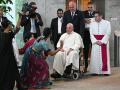 Pope Francis (C) is welcomed upon arrival at Changi airport in Singapore on September 11, 2024. Pope Francis touched down in Singapore on September 11, the last stop of a four-nation Asia-Pacific trip. (Photo by Tiziana FABI / AFP)