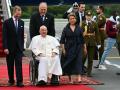 Pope Francis (C) is welcomed by Grand Duke Henri of Luxembourg (L) and his wife Grand Duchess Maria Teresa of Luxembourg (C-R) at the Luxembourg Findel international airport, where he will start a four-day apostolic journey in Luxembourg and Belgium, on September 26, 2024. (Photo by Alberto PIZZOLI / AFP)
