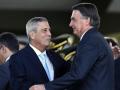 (FILES) Brazilian President Jair Bolsonaro (R) greets vice presidential candidate Walter Souza Braga Netto during the celebration of Soldier's Day at the Army headquarters in Brasilia, on August 25, 2022. Brazilian authorities on December 14, 2024 arrested former defense minister Braga Netto, a close ally of far-right ex-president Jair Bolsonaro, as part of an investigation into an alleged coup plot, a police source told AFP. (Photo by EVARISTO SA / AFP)
