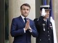French President Emmanuel Macron (C) gestures as he awaits the arrival of US Vice-President and his wife before a working lunch, on the sidelines of the Artificial Intelligence (AI) Action Summit, at the Elysee Palace, in Paris, on February 11, 2025. (Photo by Ian LANGSDON / AFP)