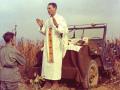 U.S. Army chaplain Father Emil Joseph Kapaun, who died May 23, 1951, in a North Korean prisoner of war camp, is pictured celebrating Mass from the hood of a jeep Oct. 7, 1950, in South Korea. He is a candidate for sainthood.  (CNS photo/courtesy U.S. Army medic Raymond Skeehan)