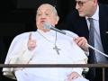 Pope Francis addresses the crowd from a window of the Gemelli hospital before being discharged following a five weeks hospitalization for pneumonia, in Rome on March 23, 2025. Pope Francis is to leave hospital todayand return to his residence in the Vatican, where he is to spend "at least two months" recovering, one of his doctors announced during a press conference on March 22, 2025. (Photo by Filippo MONTEFORTE / AFP)