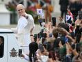 Pope Leo XIV waves to the crowd during the weekly general audience at St Peter's Square in The Vatican on May 21, 2025. (Photo by Alberto PIZZOLI / AFP)