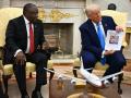 El presidente estadounidense Donald Trump muestra una fotografía de su reunión con el presidente sudafricano Cyril Ramaphosa en la Oficina Oval de la Casa Blanca en Washington, D.C.