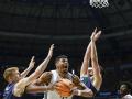 Los jugadores del Unicaja y el Madrid luchan por una bola