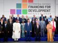 Spanish Prime Minister Pedro Sanchez (CL) and United Nations Secretary-General Antonio Guterres (CR) pose for a family photo with the rest of heads of state and representatives attending the United Nations 4th International Conference on Financing and Development in Seville, on June 30, 2025. A UN conference aiming to rally fresh support for development aid begins in Spain today with the sector in crisis as US-led funding cuts jeopardise the fight against poverty. At least 50 world leaders including French President Emmanuel Macron, Kenya's William Ruto, EU chief Ursula von der Leyen and UN head Antonio Guterres will gather in the city of Seville from June 30 to July 3. (Photo by CRISTINA QUICLER / AFP)