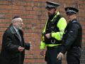 Agentes de policía conversan con un miembro de la comunidad local cerca de la sinagoga de la Congregación Hebrea de Heaton Park en Crumpsall, al norte de Mánchester