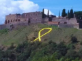 La ladera del castillo de Hostalric, con el lazo amarillo gigante visible desde la autopista