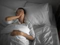 Woman feeling sick and tired in the bed.