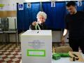 A women prepares to cast her ballot in a polling station on the first day to vote for the Italian constitutional referendum on justice reform, in Milan, on March 22, 2026. (Photo by Piero CRUCIATTI / AFP)