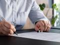 Lawyer signing an official document in the office