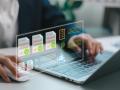 Businessperson using laptop with digital invoice and finance icons. Concept of electronic billing, invoice management, accounting automation, financial reporting, and paperless office system.