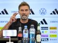 Newly appointed German coach Jurgen Klopp addresses a press conference at the headquarters of the German Football Federation (DFB) in Frankfurt am Main, western Germany on July 24, 2026. Jurgen Klopp was named as the new head coach of the German men's national football team on July 24, replacing Julian Nagelsmann who was dismissed after the team's disappointing World Cup performance. Klopp, famed for his success during stints as coach at Borussia Dortmund and especially Liverpool, has been in talks with the DFB about trying to lead Germany -- long a football powerhouse -- back to prominence. (Photo by John MACDOUGALL / AFP)