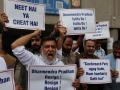 SRINAGAR (India), 25/07/2026.- Members of the Aam Aadmi Party (AAP) shout slogans and hold placards during a protest in support of the Cockroach Janta Party's (CJP) ongoing movement demanding educational reforms, in Srinagar, Kashmir, India, 25 July 2026. CJP supporters continued their protest since 20 July, when they marched toward India's Parliament to call for the resignation of the country's education minister and education reforms, leading to police crackdowns. The signs held by the protestors read: 'Dharmendra Pradhan Resign Resign Resign (top, L)' and Cockroach Party move forward, we are with you! (bottom, R)' (Protestas) EFE/EPA/FAROOQ KHAN