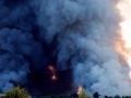 A firefighting helicopter attempts to extinguish a fire at the Russian e-commerce firm Wildberries' logistics complexes in the town of Elektrostal outside Moscow on July 18, 2026. A Ukrainian drone attack on two logistics centres in Russia killed eight people and injured 24, officials said on July 18, 2026, when the Moscow region reported a new wave of drone strikes. Russian e-commerce firm Wildberries said its logistics complexes in Kotovsk and Elektrostal, in the Tambov and Moscow regions respectively, came under attack. One person was killed and 37 were injured at the Elektrostal warehouse, according to the region's governor, Andrei Vorobyov. (Photo by TATYANA MAKEYEVA / AFP)