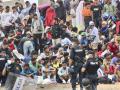 Un grupo de policías custodiando a un grupo de inmigrantes ilegales en Ceuta