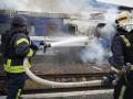 Bomberos rociando agua sobre un vagón de tren dañado por un ataque con drones cerca de la frontera con Polonia. Polonia y Ucrania