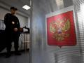 A policeman stands next to a ballot box during Russia's parliamentary election at a polling station in Moscow on September 20, 2026. (Photo by Alexander NEMENOV / AFP)