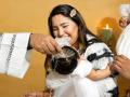 Una madre, feliz en el bautismo de su hija