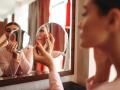 Young woman doing makeup in front of the mirror in the bedroom. Female person cares for skin. Morning face hygiene.the,doing,makeup,mirror,face,hygiene,in,morning, mirror, bedroom, pierglass, beauty, female, indoor, woman, beautiful, looking, face, young, brush, attractive, reflection, home, care, skin, pretty, girl, person, wash, white, happy, smile, routine, people, caucasian, acne, lifestyle, treatment, one, makeup, portrait, healthy, natural, health, hygiene, cosmetics, clean, up, pajama, fresh, touching, body, skincare, freshness, pampering, lady