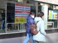 Two women pass in front of an employment office in Madrid