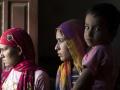 Women mourn the death of three married sisters and two of their children, who were found dead in a well in Dudu village on May 28, at the deceased family's home in Chhapya village of India's Rajasthan state on May 31, 2022. - Before the three sisters and their children were found dead in a well, they left a message blaming the family they had married into. Kalu, Kamlesh and Mamta Meena were victims of a dispute over dowries, the often hefty sums Indian parents pay to marry off their daughters. (Photo by Xavier Galiana / AFP)