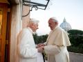 Pope Emeritus Benedict XVI, left, welcomes Pope Francis greetings, at the Vatican, Monday, Dec. 23, 2013.