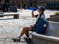 Un peregrino bebe agua en la plaza del Mercado de Logroño