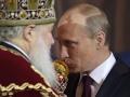 Russian Prime Minister and President-elect Vladimir Putin, right, kisses an Easter egg he was presented by Russian Orthodox Patriarch Kirill, left, during the Easter service in the Christ the Savior Cathedral in Moscow, Russia, Sunday, April 15, 2012