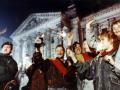 Youth light flares in front of Berlin's Reichstag early Oct. 3, 1990 to celebrate German unification. At left is a riot policeman guarding the parliament building.  (AP Photo/Diether Endlicher)