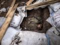 EDITORS NOTE: Graphic content / -- AFP PICTURES OF THE YEAR 2022 --

The body of a Russian soldier lays in a trench after the Ukranian troops retook the village of Mala Rogan, east of Kharkiv, on March 30, 2022. - The village of Mala Rogan was recaptured over the weekend, but it took nearly three days to fully clear the area, with Ukrainian troops going from house to house to look for Russian soldiers who had taken refuge in cellars. On March 30, 2022, an ambulance was collecting dead bodies in bags. (Photo by FADEL SENNA / AFP) / AFP PICTURES OF THE YEAR 2022