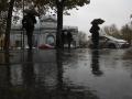 Varias personas se protegen con el paraguas de la lluvia en Madrid
