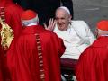 Pope Francis, seated in his wheelchair, goes to salute Cardinals at the end of the Palm Sunday mass on April 2, 2023 at St. Peter's square in The Vatican. (Photo by Vincenzo PINTO / AFP)