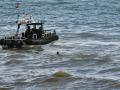 Una lancha de la Guardia Civil acude a rescatar a un migrante marroquí que nada frente a la playa del Tarajal, en Ceuta, en 2021