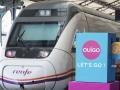 Un tren de Renfe pasa junto a un cartel publicitario de Ouigo, esta mañana en Valladolid