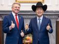 El presidente de Taiwán, Lai Ching-te (D), posando con un sombrero recibido del congresista estadounidense Michael McCaul (Iz)