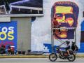 A man paints a mural depicting Venezuelan President Nicola Maduro in a highway in Caracas on June 5, 2024. Venezuela is to hold presidential elections on July 28, 2024. (Photo by Juan BARRETO / AFP)