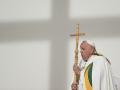 Pope Francis holds a cross during at holy mass a King Baudouin stadium, in Brussels on September 29, 2024. The pope is on a four-day apostolic journey to Luxembourg and Belgium. (Photo by Alberto PIZZOLI / AFP)