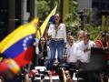 (FILES) Venezuelan opposition leader Maria Corina Machado signs the Venezuelan national anthem during a rally in Caracas on August 28, 2024. The Venezuelan Attorney General's Office opened on November 22 a new investigation against opposition leader María Corina Machado, accused of treason for conspiring with the government of Joe Biden to promote in the United States a bill to further economically isolate the Executive of Nicolás Maduro. (Photo by Pedro Rances Mattey / AFP)