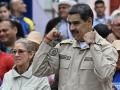 Venezuela's President Nicolas Maduro gestures next to First Lady Cilia Flores during an event marking the 165th anniversary of the Battle of Santa Ines in Caracas on December 10, 2024. (Photo by Juan BARRETO / AFP)