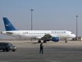 Un trabajador del aeropuerto camina por la pista junto a un avión de Syrian Air en el Aeropuerto Internacional de Damasco