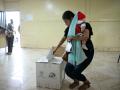 A woman with her baby casts her vote at a polling station during the presidential election in Canuto, Manabi province, Ecuador, on February 9, 2025. Some 14 million Ecuadorans began voting Sunday to decide who will lead the violence-wracked Andean nation through its worst crisis in half a century. (Photo by Rodrigo BUENDIA / AFP)