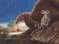 Reconstrucción en vida de la Formación Baynshire, Mongolia, que muestra a Ravjaa ishiii (primer plano), una especie de mamífero recientemente descubierta, representada en el pie del dinosaurio hadrosáurido Gobihadros